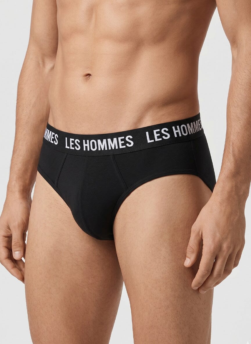 black brief underwear on a male model with a white Les Hommes logo waistband