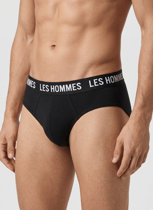 black brief underwear on a male model with a white Les Hommes logo waistband
