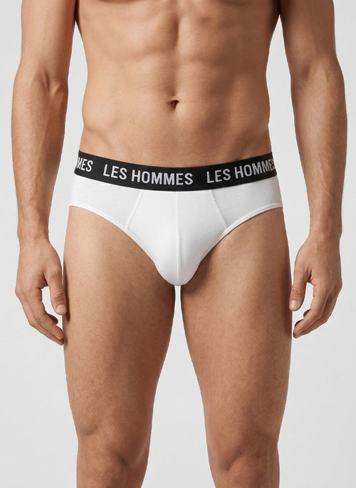 man wears white briefs with a black elastic waistband reading les hommes across the front and sides
