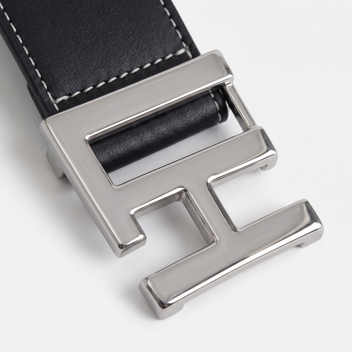 Les Hommes Black Belt with black leather strap and polished silver buckle, a masculine accessory for formal wear.