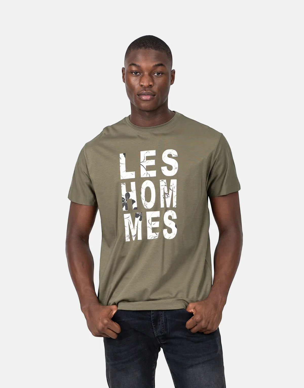 Olive green Les Hommes chest graphic t-shirt modeled by a man, featuring a distressed white logo.