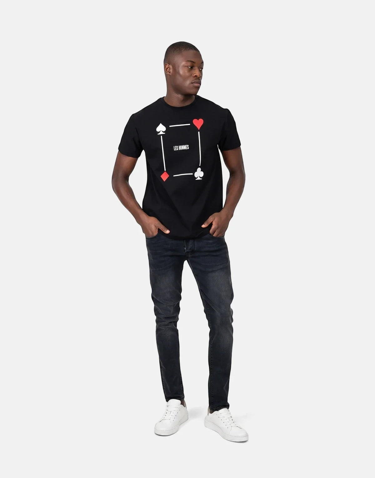 Men's Les Hommes black t-shirt featuring a distinctive poker card suit graphic print, paired with black jeans and white